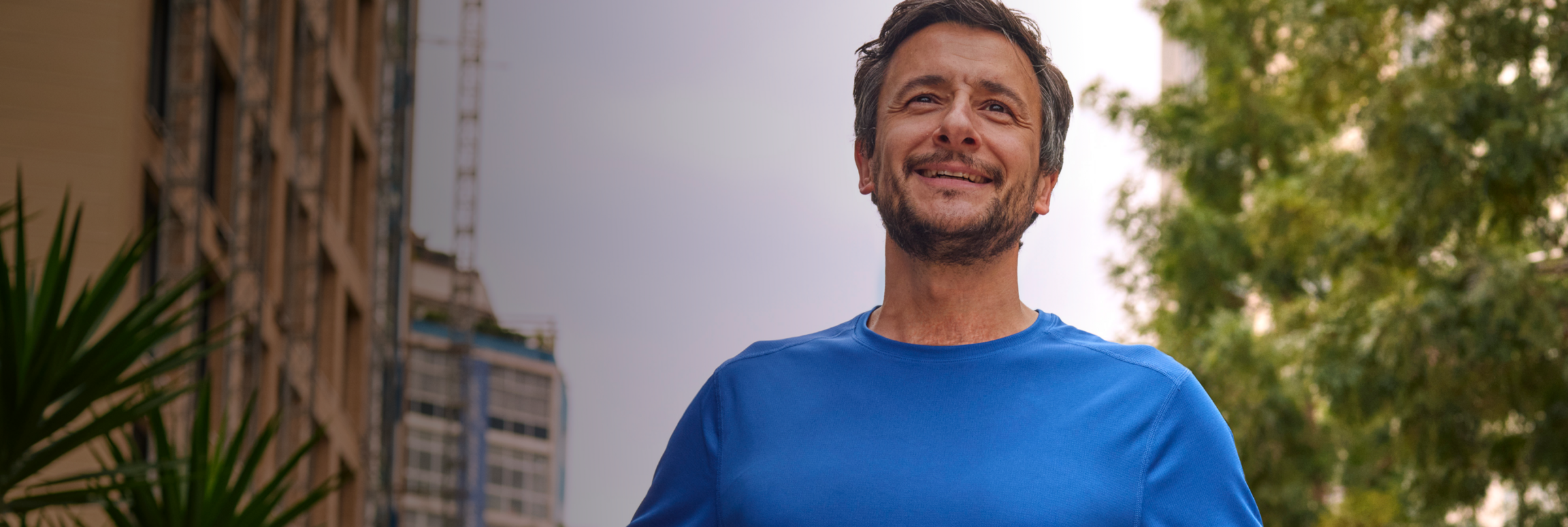 Man standing outside in the sun. Patient portrayal.